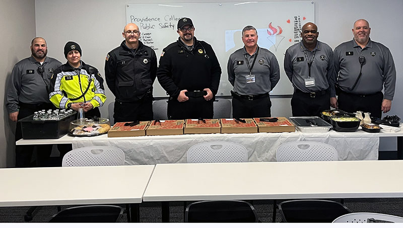 members of public safety standing at a table thanking donors