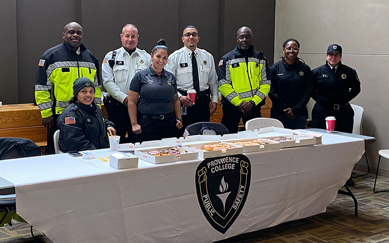 The Public Safety team standing behind a table greeting people